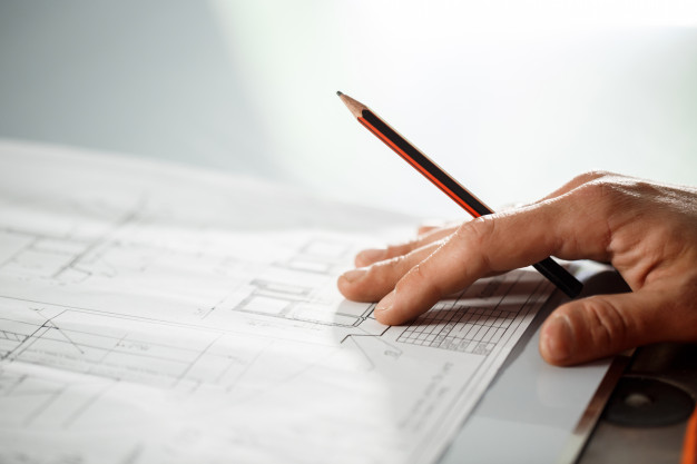 close-up-worker-s-hand-drawing_176420-11763